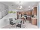 Bright dining area with modern chandelier, adjacent to the kitchen with stainless steel appliances at 10162 E Theorem Dr, Mesa, AZ 85212
