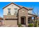 Charming two-story home features a stone facade, attached two-car garage, and manicured landscaping at 10162 E Theorem Dr, Mesa, AZ 85212