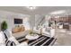 Inviting living room features tile flooring, modern furniture, and seamlessly connects to the kitchen area at 10162 E Theorem Dr, Mesa, AZ 85212