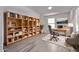 Bright office space with built-in bookshelves, a spacious desk, and comfortable seating arrangement at 10162 E Theorem Dr, Mesa, AZ 85212