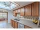 Bright kitchen featuring wood cabinets, neutral countertops, and natural light at 1023 E Rosemonte Dr, Phoenix, AZ 85024