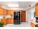 Traditional kitchen featuring wood cabinets, white counters, and a stainless steel refrigerator at 10646 E Ironwood Ln, Mesa, AZ 85208