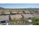 An aerial perspective of the house displays mature vegetation in the back adjacent to other similar houses at 10796 E Betony Dr, Scottsdale, AZ 85255