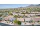 An aerial view of a neighborhood in a desert setting with homes that have desert landscaping and mountain views at 10796 E Betony Dr, Scottsdale, AZ 85255