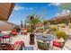 Backyard patio includes seating around a stone feature and mountain views at 10796 E Betony Dr, Scottsdale, AZ 85255