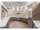 Modern community kitchen with stainless steel appliances, stone backsplash, and elegant countertop space at 10796 E Betony Dr, Scottsdale, AZ 85255