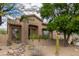 Front exterior of the home displays desert landscaping, stucco walls, and a tile roof at 10796 E Betony Dr, Scottsdale, AZ 85255