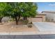 Single-story home with a 2 car garage features desert landscaping and mature trees at 10796 E Betony Dr, Scottsdale, AZ 85255