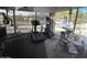 An interior view of an indoor fitness center with exercise equipment, large windows, and a view of the desert landscape at 10796 E Betony Dr, Scottsdale, AZ 85255