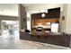 A kitchen that features tile flooring, brown trim, and modern appliances; the kitchen sits next to an outdoor living space at 10796 E Betony Dr, Scottsdale, AZ 85255