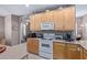 Cozy kitchen with tile flooring, appliances, and ample cabinet space for storage and organization at 10796 E Betony Dr, Scottsdale, AZ 85255