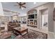 Open-concept living room with built-in shelving and seamless flow to the kitchen and dining area at 10796 E Betony Dr, Scottsdale, AZ 85255