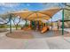 Shaded community playground with slides, climbing structures, and benches at 10796 E Betony Dr, Scottsdale, AZ 85255