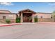 Charming kitchen and patio with wooden entryway, stone accents, and mature desert landscaping at 10796 E Betony Dr, Scottsdale, AZ 85255