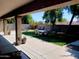 The spacious covered patio overlooks a lush backyard, perfect for relaxing and entertaining outdoors at 11219 N 165Th Ave, Surprise, AZ 85388