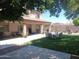 The spacious backyard with a covered patio offers a perfect blend of relaxation and entertainment with a lawn and barbecue area at 11219 N 165Th Ave, Surprise, AZ 85388