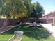 Relax in this beautiful backyard with artificial turf, providing a low-maintenance outdoor space perfect for entertaining at 11219 N 165Th Ave, Surprise, AZ 85388