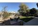 Landscaped backyard with seating area and artificial turf, creating a serene outdoor retreat at 11219 N 165Th Ave, Surprise, AZ 85388