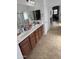 The bathroom has a double sink vanity and large mirror at 11219 N 165Th Ave, Surprise, AZ 85388