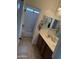 A well-lit bathroom featuring a double vanity and a shower-tub combination at 11219 N 165Th Ave, Surprise, AZ 85388