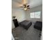 Simple bedroom with a dark covered queen bed and ceiling fan at 11219 N 165Th Ave, Surprise, AZ 85388