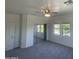 Neutral bedroom with gray carpet, mirrored closet doors and white trim and ceiling fan at 11219 N 165Th Ave, Surprise, AZ 85388
