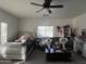 Bright bedroom featuring a fan, a bed, a sofa, and a desk at 11219 N 165Th Ave, Surprise, AZ 85388
