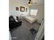 Well-lit bedroom with a twin bed and dark sofa at 11219 N 165Th Ave, Surprise, AZ 85388