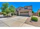 Charming two-story home featuring a well-manicured front yard, a driveway, and an attached two-car garage at 11219 N 165Th Ave, Surprise, AZ 85388
