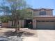 Charming two-story home featuring a well-maintained front yard and neutral stucco at 11219 N 165Th Ave, Surprise, AZ 85388