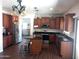 A stylish kitchen features wood cabinets, dark countertops and stainless appliances and an island at 11219 N 165Th Ave, Surprise, AZ 85388