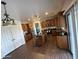Modern kitchen featuring wood cabinetry, stainless steel appliances, an island, and updated flooring at 11219 N 165Th Ave, Surprise, AZ 85388
