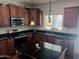 This kitchen shows dark countertops and stainless steel appliances and fixtures at 11219 N 165Th Ave, Surprise, AZ 85388