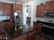 This kitchen showcases wood cabinets, a stainless steel fridge, and a dark granite island at 11219 N 165Th Ave, Surprise, AZ 85388