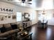 Bright living room featuring hardwood floors, a ceiling fan, and white walls at 11219 N 165Th Ave, Surprise, AZ 85388
