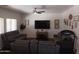 A comfortable living room features large windows and plush, gray seating at 11219 N 165Th Ave, Surprise, AZ 85388