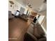 Bright, open living room with hardwood floors and modern ceiling fan fixture at 11219 N 165Th Ave, Surprise, AZ 85388