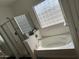 The main bathroom features a soaking tub and a glass enclosed shower at 11219 N 165Th Ave, Surprise, AZ 85388