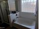 Relax in this bathroom's stylish tub or enjoy a refreshing shower in the enclosed glass shower at 11219 N 165Th Ave, Surprise, AZ 85388