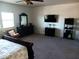 The spacious main bedroom features a large window, a modern dresser, and a TV for your entertainment at 11219 N 165Th Ave, Surprise, AZ 85388