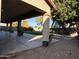 Covered patio offering a relaxing outdoor space with views of the landscaped backyard at 11219 N 165Th Ave, Surprise, AZ 85388