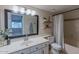 Bright bathroom featuring a large mirror, vanity with sink, and a shower-tub combination at 11333 N 92Nd St # 2080, Scottsdale, AZ 85260