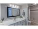 Modern bathroom with white cabinets, a large mirror, vanity with sink, and a shower-tub combination at 11333 N 92Nd St # 2080, Scottsdale, AZ 85260
