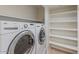 Laundry room with washer, dryer, and built-in shelves for storage at 11333 N 92Nd St # 2080, Scottsdale, AZ 85260