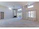 Spacious living room featuring vaulted ceilings, a fireplace, and large windows at 11333 N 92Nd St # 2080, Scottsdale, AZ 85260