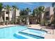 Beautiful community pool and spa surrounded by mature palm trees and shaded pergola at 11333 N 92Nd St # 2080, Scottsdale, AZ 85260