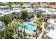 Aerial view of a community pool surrounded by lush palms trees and walkways to condos at 11333 N 92Nd St # 2080, Scottsdale, AZ 85260