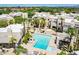 Aerial view of a community pool with lounge chairs, palm trees and white condos surrounding it at 11333 N 92Nd St # 2080, Scottsdale, AZ 85260