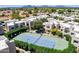 An aerial shot shows a tennis court with surrounding condos and desert landscape in the background at 11333 N 92Nd St # 2080, Scottsdale, AZ 85260