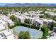Aerial view of a blue tennis court with lush green landscaping surrounding it, located in a condo community at 11333 N 92Nd St # 2080, Scottsdale, AZ 85260
